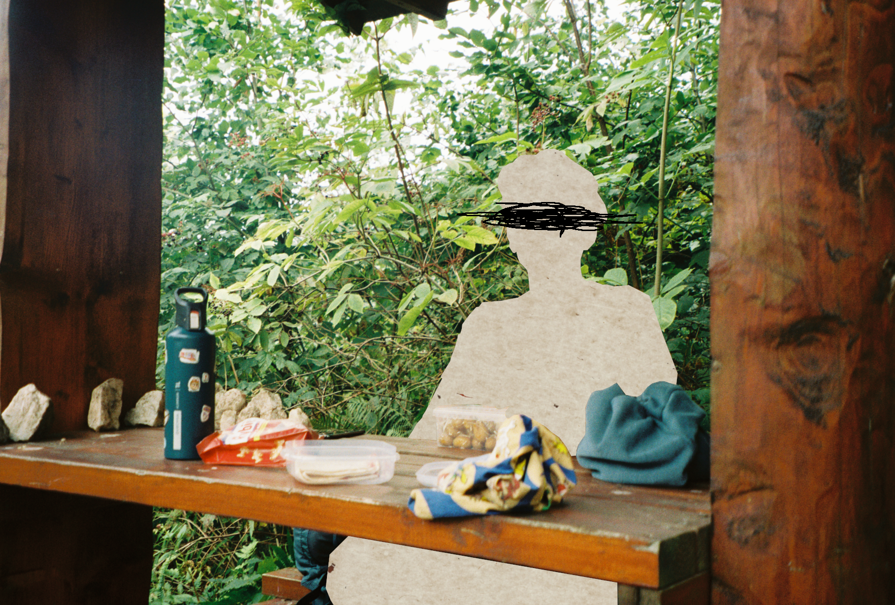 A photo of a person sitting at a bench with food on the bench. The person is cropped out and instead of them there is a paper texture with scribbles in their eye level